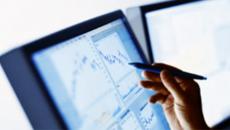 Hand with pen pointing at display screen Hand with pen pointing at display screen