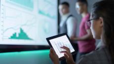 Businessperson viewing graphs on a tablet