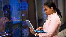 IT checks info on laptop in front of IT room IT checks info on laptop in front of IT room