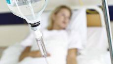 Patient lying in hospital bed with IV drip Patient lying in hospital bed with IV drip