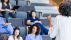 Alt text: A university instructor lecturing college students Alt text: A university instructor lecturing college students