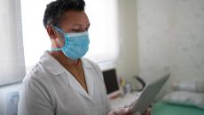 Nurse checks her tablet