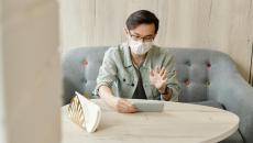 A patient wearing mask at home in an online consultation.