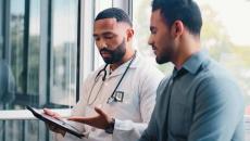 Doctor showing tablet to patient Doctor showing tablet to patient