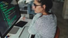 Person looking at code on a computer screen Person looking at code on a computer screen