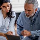Doctor showing tablet to patient